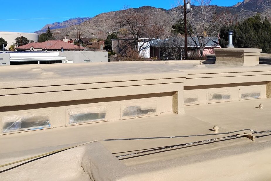 Albuquerque Heights home roof with closed-cell spray foam on the deck and parapet walls, Sandia Mountains behind