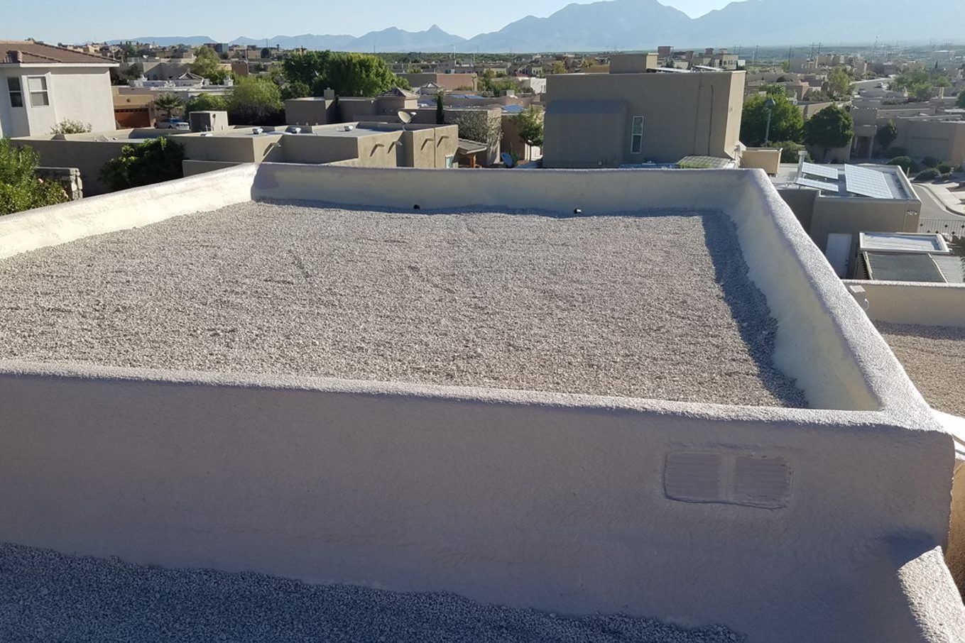 Spray foam and gravel roof with foamed and coated parapet walls on a Las Cruces residence
