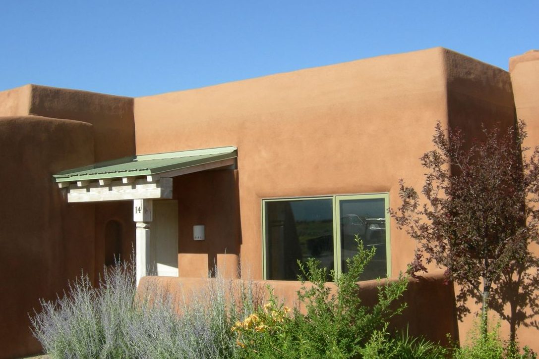 Adobe-style home after parapet repair and a new synthetic stucco finish