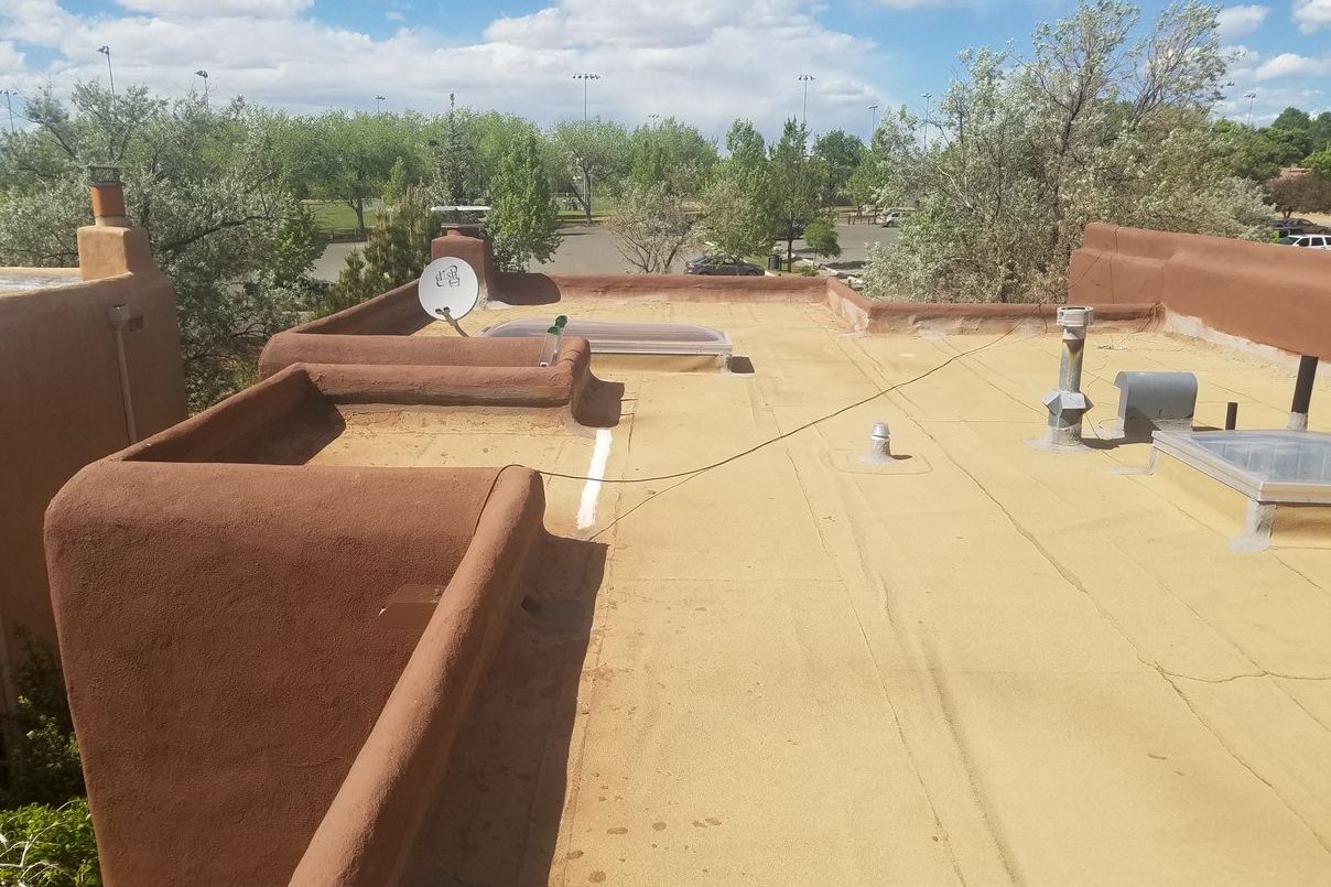 Completed spray foam condo re-roof in Santa Fe with adobe parapet walls
