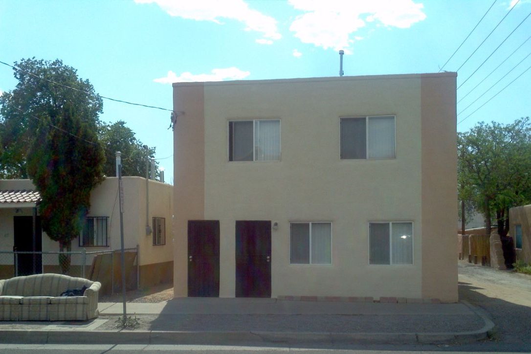 Two-story apartment building near UNM with its new finish over spray foam walls